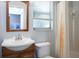Clean bathroom with wood-framed mirror, classic white sink, and shower at 333 Bay Pl, Safety Harbor, FL 34695