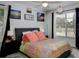A cozy bedroom features a ceiling fan, a large window, and decorative wall art at 333 Bay Pl, Safety Harbor, FL 34695