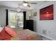 A comfortable bedroom with a ceiling fan, a window with blinds, and black curtains at 333 Bay Pl, Safety Harbor, FL 34695