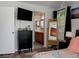A bedroom with a view into an en-suite bathroom and a large TV at 333 Bay Pl, Safety Harbor, FL 34695
