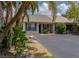 Charming exterior showcasing blue shutters and lush landscaping, offering a welcoming curb appeal at 333 Bay Pl, Safety Harbor, FL 34695