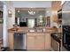 An open kitchen offers a view of the living space, featuring stainless steel appliances and wood cabinets at 333 Bay Pl, Safety Harbor, FL 34695