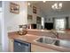 An open kitchen overlooks the living area, with stainless steel appliances and wood cabinets at 333 Bay Pl, Safety Harbor, FL 34695