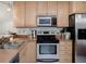 A kitchen with stainless steel appliances, wood cabinets, and ample counter space at 333 Bay Pl, Safety Harbor, FL 34695