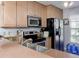 A bright kitchen with stainless steel appliances, including a refrigerator, oven, and microwave at 333 Bay Pl, Safety Harbor, FL 34695