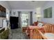 Bright living area with wood floors and a view of the lanai, creating a seamless indoor-outdoor experience at 333 Bay Pl, Safety Harbor, FL 34695