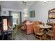 Comfortable living room with vaulted ceiling, wood floors, and sliding glass doors to a lanai at 333 Bay Pl, Safety Harbor, FL 34695