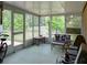 Enclosed sunroom with neutral decor, comfortable seating, and a peaceful yard view at 333 Bay Pl, Safety Harbor, FL 34695