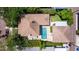 Aerial view showcasing the backyard pool and patio and the property's well-manicured landscape at 341 14Th Ave Ne, St Petersburg, FL 33701