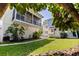 Charming backyard featuring lush green grass, a well-manicured landscape, and a screened in porch at 341 14Th Ave Ne, St Petersburg, FL 33701
