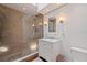 Modern bathroom featuring a glass-enclosed shower and a vanity with marble countertop at 341 14Th Ave Ne, St Petersburg, FL 33701