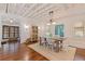 Dining room with hardwood floors, modern light fixture, cabinet and bright natural light at 341 14Th Ave Ne, St Petersburg, FL 33701