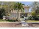 Charming two-story home with a quaint front porch, palm trees and manicured landscaping at 341 14Th Ave Ne, St Petersburg, FL 33701
