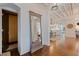 Elegant foyer with hardwood floors, high ceilings, decorative mirror, and open view to dining and kitchen at 341 14Th Ave Ne, St Petersburg, FL 33701