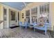 Inviting front porch featuring tile flooring, comfortable chairs, and a blue painted ceiling at 341 14Th Ave Ne, St Petersburg, FL 33701