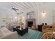 Bright living room with a fireplace, hardwood floors, ceiling fan, and exposed beam ceiling at 341 14Th Ave Ne, St Petersburg, FL 33701