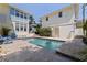 Home exterior with pool featuring stone patio, blue lounge chairs, and garden at 341 14Th Ave Ne, St Petersburg, FL 33701