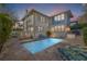 Backyard pool view during sunset with a two-story home, patio and lounge chairs at 341 14Th Ave Ne, St Petersburg, FL 33701