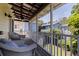 Relaxing screened porch with comfortable seating and views of the surrounding neighborhood at 341 14Th Ave Ne, St Petersburg, FL 33701