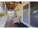 Charming screened-in porch with comfortable seating and an outside view of neighboring houses at 341 14Th Ave Ne, St Petersburg, FL 33701