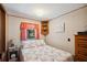 Cozy bedroom with a patterned comforter, bedside tables, and natural light from the window at 34125 Chancey Rd, Wesley Chapel, FL 33543