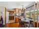 Sun-filled breakfast nook featuring a charming chandelier, wood table and outdoor view at 34125 Chancey Rd, Wesley Chapel, FL 33543