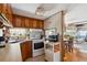 View of the kitchen and breakfast nook offering wood cabinets, oven and adjacent living area at 34125 Chancey Rd, Wesley Chapel, FL 33543
