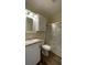 Clean bathroom with vanity, toilet, and glass-enclosed shower stall, plus overhead storage at 3722 Binnacle Dr, Tampa, FL 33611