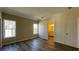 An airy bedroom has hardwood-style floors and an ensuite bathroom at 3722 Binnacle Dr, Tampa, FL 33611