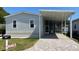 Charming home exterior features a screened-in porch, paved driveway, and well-maintained lawn at 3722 Binnacle Dr, Tampa, FL 33611