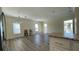 Living room with vinyl floors, large windows, and easy access to the kitchen area at 3722 Binnacle Dr, Tampa, FL 33611