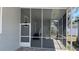 View of the home's screened in patio featuring an outside entry and access to the main home at 3722 Binnacle Dr, Tampa, FL 33611
