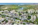 Expansive aerial view showcasing a residential neighborhood with waterfront homes and natural waterways in the distance at 3813 Luma Dr, Holiday, FL 34691