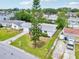 Aerial front view of the home highlighting the well-manicured lawn, driveway, and surrounding neighborhood at 3813 Luma Dr, Holiday, FL 34691