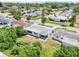 Aerial view of a modest home with a patio and backyard in a residential neighborhood; lots of foliage at 3813 Luma Dr, Holiday, FL 34691
