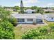 A well maintained backyard features an enclosed porch and a quaint patio, perfect for relaxing outdoors at 3813 Luma Dr, Holiday, FL 34691