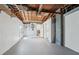 Unfinished basement featuring an exposed wood ceiling and a view to the bathroom at 3813 Luma Dr, Holiday, FL 34691