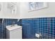 Bathroom featuring bright blue tiled walls, a small vanity, and a mirror at 3813 Luma Dr, Holiday, FL 34691