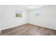 Cozy bedroom features hardwood floors, a ceiling fan, and windows for lots of natural light at 3813 Luma Dr, Holiday, FL 34691