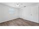 Clean bedroom with hardwood floors, ceiling fan, window and closet at 3813 Luma Dr, Holiday, FL 34691