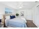 Bedroom with a large bed, neutral walls, a ceiling fan, and cozy decor at 3813 Luma Dr, Holiday, FL 34691