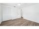 Bright bedroom featuring wood floors, a ceiling fan, and a closet at 3813 Luma Dr, Holiday, FL 34691