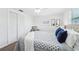 Bedroom featuring wood-look floors, a window, and a closet with large folding doors at 3813 Luma Dr, Holiday, FL 34691