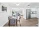 Dining area with hardwood floors, open to the living room and kitchen, creating an inviting space at 3813 Luma Dr, Holiday, FL 34691