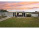 Charming single-story home featuring a well-maintained lawn, attached garage and inviting front patio at 3813 Luma Dr, Holiday, FL 34691