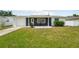Charming single-story home featuring a well-maintained lawn, attached garage and inviting front patio at 3813 Luma Dr, Holiday, FL 34691