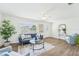 Inviting living room featuring hardwood floors, a navy blue sofa, white walls, and natural light at 3813 Luma Dr, Holiday, FL 34691