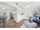 Open-concept layout with hardwood floors connecting the dining area, kitchen, and living room seamlessly at 3813 Luma Dr, Holiday, FL 34691