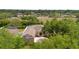 Aerial view of the house showcasing its front entrance, roof, and lush surrounding trees and landscaping at 4022 Valrico Grove Dr, Valrico, FL 33594