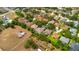 Expansive aerial view of a neighborhood with mature trees, well-maintained lawns, and various home styles at 4022 Valrico Grove Dr, Valrico, FL 33594